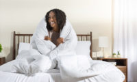 Woman snuggling with her down alternative duvet