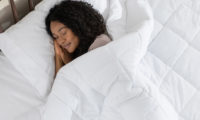 Woman sleeping peacefully, covered by her down alternative duvet
